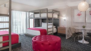 Bunk Bed Suite bedroom showing four beds, two below with two bunks as well as a seating area for 4 Bunk Bed Suite bedroom showing four beds, two below with two bunks as well as a seating area for 4