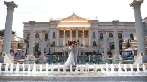 Bride and Groom embracing by the Neptune Pool at Caesars Palace Bride and Groom embracing by the Neptune Pool at Caesars Palace