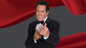 Wayne Newton in front of a red curtian Wayne Newton in front of a red curtian