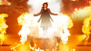 Criss Angel on the stage, surrounded by fire. Criss Angel on the stage, surrounded by fire.